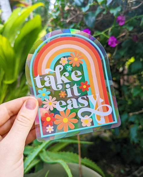 "Bathe your home (+ yourself!) in gorgeous bursts of rainbows.  Directions: apply your new suncatcher decal to a window with * direct * sunlight (this is really important!) & watch vibrant rainbows bathe your space! ⋒ Created & shipped from our art studio on Kauaʻi, Hawaiʻi.🌈 This retro suncathcer is 4\" x 5\" and says \"take it easy\" :) Stickers are designed, manufactured, and printed in the USA. All stickers & stationery products ship from our art studio in Hawaii. © Color Oasis | All Rights Reserved ✌ Check out more of our sticker and stationery designs here: https://www.etsy.com/shop/ColorOasisHawaii Need a larger quantity of these suncatcher stickers? Contact us! We'd be happy to work with you :-) Please note: Our suncatcher stickers will work on any indoor windows that get direct s Easy Stickers, Suncatcher Stickers, Indoor Windows, Groovy Rainbow, Suncatcher Sticker, Sticker Design Inspiration, Stickers Stationery, Suncatcher Window, Stationery Products