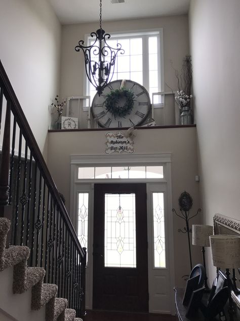 Front Door Ledge Decor, Decorating Above Doorways, Above The Stairs Decor, Ledge Over Front Door Entryway, High Ceiling Landing Ideas, Above Front Door Decor Interior Foyer, Vaulted Ceiling Ledge Decor Living Room, Foyer Shelf Decor Entryway, Stair Shelf Decor Stairways