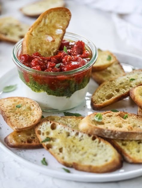 This ricotta jam jar is the perfect appetizer and snack to serve at a party! Based on the ricotta jam jar served at Nordstrom Cafe, it starts with creamy ricotta, is topped with flavorful basil pesto and a quick tomato jam. Serve with crunchy bread and dip dip dip! I howsweeteats.com #ricotta #jam #jar #nordstrom #tomato #pesto #appetizer #dip Bread And Dip, Nordstrom Cafe, Crunchy Bread, Dip Dip, Light Appetizers, Tomato Jam, Tomato Pesto, Dips Appetizers, Chops Recipe