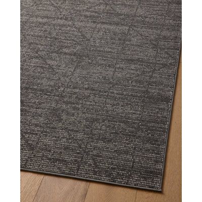 This rustic area rug balances your living room or office with a neutral foundation. Featuring a subtle geometric pattern, it shows off charcoal and ivory hues with a diamond stripe motif. We love that it has a distressed finish that adds a lived-in vibe. Power-loomed from polyester, this rug has a low 0.25'' pile height that holds up in high-traffic spaces where it won't trip up your feet or your vacuum. Plus, it's fade- and stain-resistant, so it holds up in busy homes and sunny rooms. Although Charcoal Area Rug Living Room, Charcoal Rug Living Room, Masculine Rugs Living Room, Man Cave Rug, Office Area Rug, Dark Rug Living Room, Dark Area Rug, Moody Rug, Dark Grey Area Rug