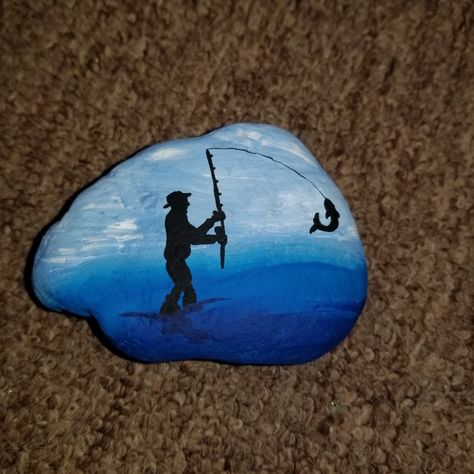 Fisherman Rock Art, Kayak Painted Rock, Lake Rock Painting Ideas, Lake Painted Rocks, Painted Rocks Fish, Fishing Rock Painting, Fishing Painted Rocks, Fisherman Painting, Fisherman Silhouette