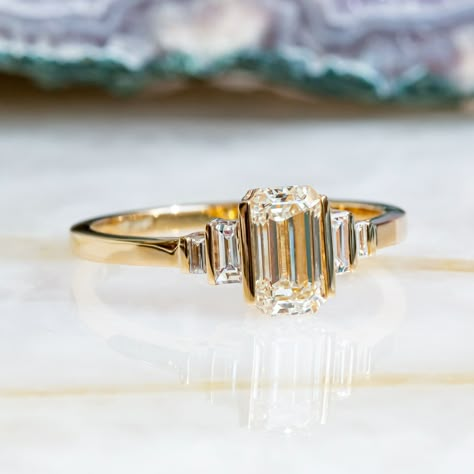 Beautiful Art Deco Engagement set with 1.11 carat of Emerald Cut cut diamond mounted in 14K Yellow gold.   Vintage Bars on top of Emerald cut & Baguettes, with Diana Rafael's light performing diamonds, makes a stunning ring, you won't ever take off!  Setting -Total Carat Weight: 1.11 carat -14K YellowGold -Size: Resizable - any size is availzble! Ask us!  -Certificate Of Authenticity Included  Main Diamonds: -Emerald Cut  -0.94 Carat -Color: G -Clarity: VS1 (Enhanced) -Cut:  Cut -Dimensions: 7.25 x 4.20  *Clarity Enhanced *Processing time* Unbeatable processing time of 3-5 business days! - custom orders is 5-7 Business days. *Shipping** We ship with FedEx Express shipping! Most items are delivered within 48-96 hours! ------------------------------------------------------------------------- Vintage Engagement Rings Unique 1920s Diamond, 3 Stone Art Deco Ring, Antique Emerald Cut Ring, Antique Bezel Ring, Bar Set Engagement Ring, Vintage Emerald Cut Engagement Ring Set, Yellow Emerald Cut Engagement Ring, Vintage Wedding Rings Emerald Cut, Baguette Emerald Engagement Ring