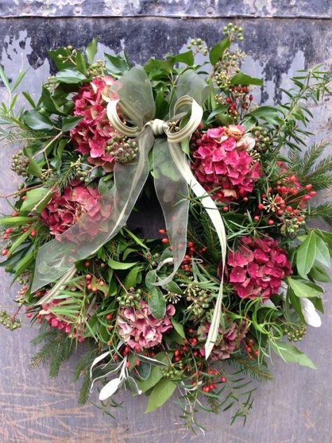 While wreaths are most commonly associated with seasonal foliage, berries and pine cones, flowers are a great way to add colour and vibrancy and give the look a contemporary twist. We love this floral wreath, which teams laurel and eucalyptus leaves with delicate pink hydrangea and deep red velveteen celosia. Raindrops And Roses, Easter Spring Wreath, Christmas Door Wreaths, Hydrangea Wreath, Wreaths And Garlands, Xmas Wreaths, Garden Gate, Christmas Flowers, Winter Wreath