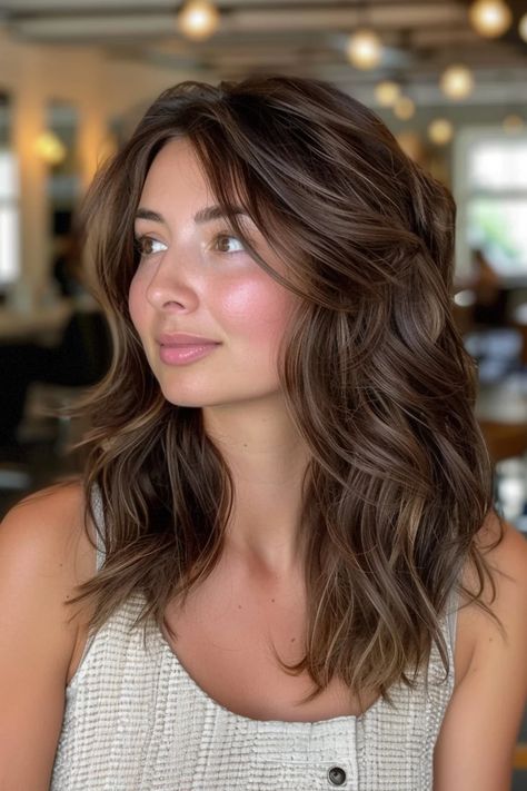 Woman with wavy brown hair gazing to the side, in a softly lit room. Hair Color For Bronze Skin, Red Hair To Brown, Ashy Caramel Balayage, Brown Hair On Tan Skin, Brown Cherry Hair, Brown Cherry Hair Color, Solid Hair Color Ideas, Hair On Tan Skin, Chocolate Lowlights