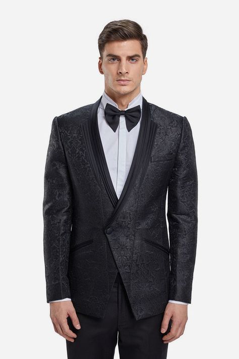 The New Dinner Jackets; a black jacquard tuxedo jacket is punctuated with a double wing pleated lapel and angular cut pocket flaps. The creation is paired with black straight trousers. Think white wing collar shirt,  bowtie and cummerbund. Finish with a pair of leather oxfords and sleek pushed back hair #GauravGupta #GauravGuptaMan #GGMan #Menswear #MensFashion #Cocktail #Reception #Groom #Tuxedo Pushed Back Hair, Charcoal Tuxedo, Menswear Indian, Demi Couture, Wing Collar Shirt, Dinner Jackets, New Dinner, White Wing, Gaurav Gupta