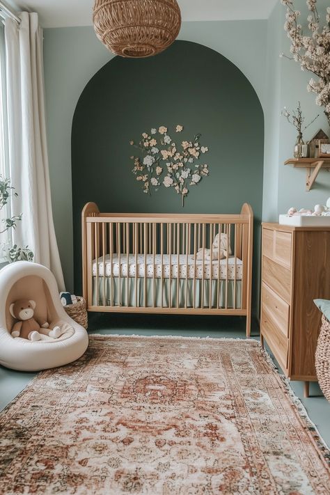 earthy toned nursery with warm, natural decor elements. Natural Nursery Colors, Natural Woodland Nursery, Gender Neutral Nursery Gray Crib, Olive Green And Brown Nursery, Arch Over Crib, Neutral Natural Nursery, Nursery Ideas Natural Wood, Mini Nursery Ideas, Olive Baby Nursery