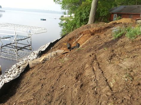 The slope being cleared and prepared for construction Steep Bank Landscaping, Garden On Steep Slope, Dry Creek Bed On Steep Slope, Sloped Lakeside Landscaping, Steep Slope Backyard Ideas, Steep Lakeside Landscaping, Landscape Steep Hillside, Prevent Erosion On A Slope, Landscaping A Steep Slope