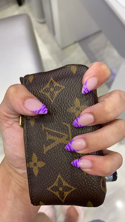 Purple french-tiped nails in the almond shape, tiger stripe pattern Blue French Tip Design Nails, Purple French Almond Nails, Bright Purple French Tip Nails, Purple Nail Almond, Pattern French Tip Nails, Patterned French Tip Nails, Purple Zebra Nails, Tiger French Nails, Clawdeen Nails