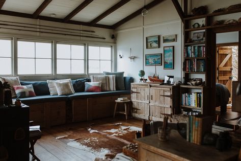 Living Room, Stools, Chair, Bookcase, Pendant Lighting, Medium Hardwood Floor, Shelves, Bench, and Rug Floor The couple built many furnishings, such as the storage chests, out of old leftover timber. Fisherman House, Off Grid House, Old Fisherman, Gravity Home, Homemade Furniture, Slice Of Heaven, Beach Shack, The Design Files, Window Seat