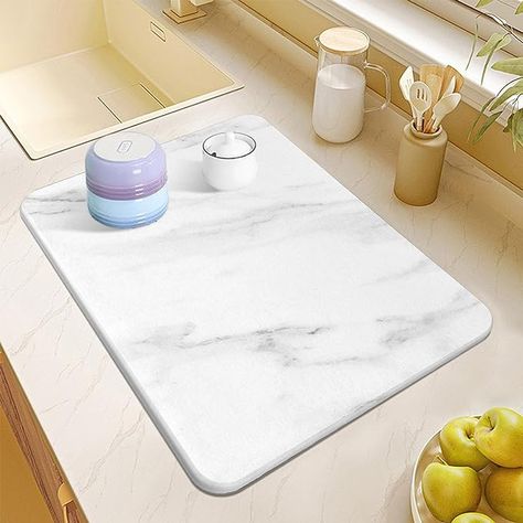 WATER ABSORPTION AND QUICK DRYING: Made of food-grade diatomaceous earth. Our dish pads are designed to remove water quickly. Now, Say goodbye to the wet and slippery kitchen counter NON-SLIP & HEAT RESISTANCE: it's a perfect heat-resistant mat up to 450°F/230°C ECO-FRIENDLY: Looking for a sustainable and plastic-free kitchen drying drying mat? Our dish pads are made of eco-friendly, high-quality, non-toxic material - Just make your kitchen and the planet a safer place Stone Mat, Plastic Free Kitchen, Diatomaceous Earth Food Grade, Counter Clutter, Sink Tray, Dog Water Bowls, Dish Rack Drying, Diatomaceous Earth, Dish Racks