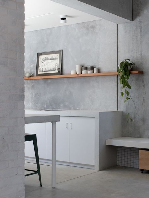 Kitchen, Concrete Counter, Ceiling Lighting, Concrete Floor, White Cabinet, and Concrete Backsplashe The entrance to the galley kitchen, with the tile repeated below the built-in bench. Concrete Countertop Ideas, Backsplash Herringbone, Tile Accent Wall, Farmhouse Backsplash, Recycled Brick, Beadboard Backsplash, Concrete Houses, Concrete Countertops Kitchen, Concrete Counter