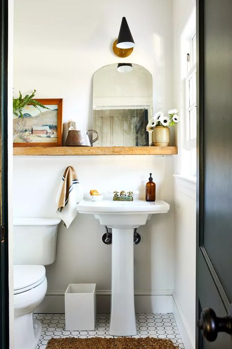 22 Powder Room Ideas That Pack Style into a Small Space Small Half Bath Pedestal Sink, White Powder Room Vanity, Eclectic Small Bathroom, Tiny Powder Room Sink, Small Powder Room Pedestal Sink, Small Guest Bathroom Pedestal Sink, Small Powder Room Design Pedestal Sink, Powder Room Shelf, Small Half Bath Ideas