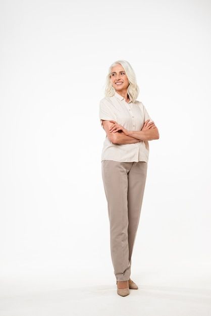 Premium Photo | Photo full length portrait of beautiful adult woman 70s with gray hair smiling and looking with arms in pockets, isolated over white wall White Backround, Logo Reference, Reference Ideas, Clothing Board, Middle Aged Women, Pose References, Old Woman, Female Portraits, Character Poses