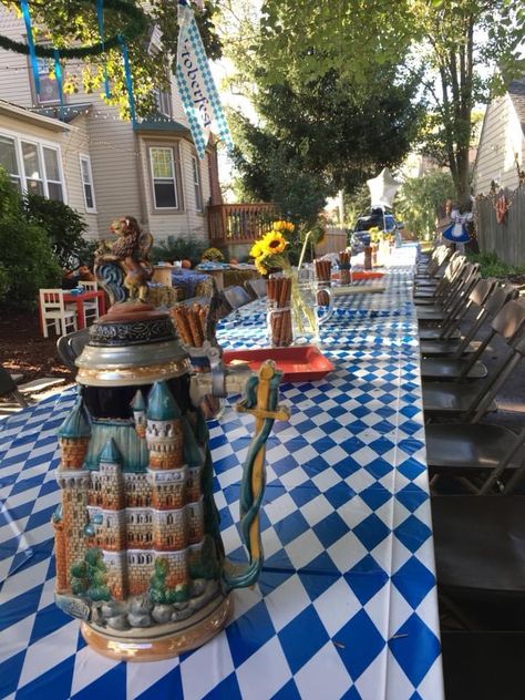 Outdoor octoberfest decor, long table with tables octoberfest blue checked table cloths, handmade wreaths hung from trees with ribbons, homemade pretzel hook, cheese and meat boards on the tables with beer steins, garage set up to look like an octoberfest tent by stapling ribbons draping from the ceiling. Photo props of scenery of Germany. A homemade cardboard cut out set I made of octoberfest outfits. I also put together a pumpkin patch for the kids. Hay for seating old flannel shirts on top Octoberfest Party Ideas, Octoberfest Party, Party Backyard, Oktoberfest Party, Backyard Party, Party Ideas, Table Decorations, Patio, Outdoor Decor