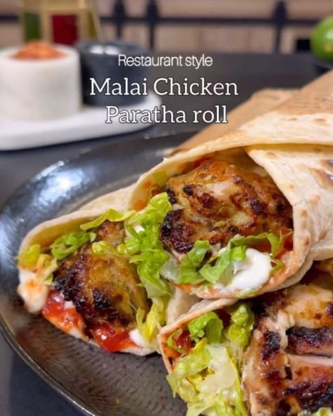 Meal Prepping on Instagram: "Malai Chicken Paratha Roll by @shadi_faleel  Savor the Creamy flavours of restaurant style Creamy Malai Chicken Paratha Roll, where juicy grilled chicken meets the rich cream of malai, all wrapped in a warm paratha. Super easy mid week recipes which will you remember Every bite is a memory..  You’ll need: 1kg Boneless chicken cubes  1 tbsp Salt 2 tbsp Ginger garlic paste 1/4 cup oil or ghee Juice of 1 lime  1/2 cup Double cream  1/2 cup Yogurt  1/2 cup Cheese 1 tsp Crushed cardamom seeds 1 tbsp Crushed coriander seeds  1 tbsp Crushed cumin seeds  1/2 tbsp Black pepper  1/2 tbsp cumin powder  1/2 tbsp garam masala  6 to 7 Mint leaves  2 to 3 Green chillies  Assemble with Paratha Mayo Ketchup  Lettuce   Follow the instructions mentioned on the video." Chicken Kathi Roll Recipes, Indian Wraps Street Food, Chicken Paratha Roll, Low Calorie Indian Chicken, Chicken Paratha, Cardamom Seeds, Paratha Roll, Chicken Malai, Chicken Cubes