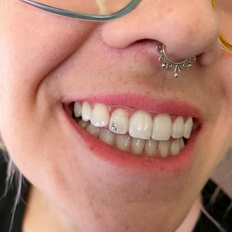 RIP to my cute little corner cap! 👋 After 9 months with this cutie I was ready for some change! I get to do so many fun designs for my clients and I want them all in myself. It’s so hard to pick one! Stay tuned, because my next set will be a surprise to both of us! 😄 #geminismile #toothgems #toothgemtechnician Smiley Piercing With Tooth Gems, Diamond Tooth Gem Aesthetic, Piercing Dental, Tooth Gem Designs, Tooth Gem Crooked Teeth, Disco Ball Tooth Gem, Tooth Gem Placement, Heart Teeth Gem, Teeth Gems