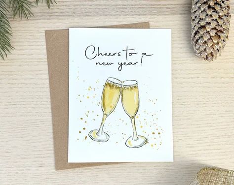 “Cheers to a New Year” New Years stationery and card set Send cheerful wishes this holiday season with this fun New Years card, featuring a hand painted watercolor design, champagne toast. This illustrated card is made with premium white linen card stock, is packaged neatly and includes sturdy peel and seal envelopes for your convenience. New Years Eve Watercolor, New Years Watercolor Ideas, New Years Card Ideas, Happy New Year Watercolor Cards, New Years Watercolor, New Year Watercolor, Watercolor Stationary, New Years Cards, New Year Card Design