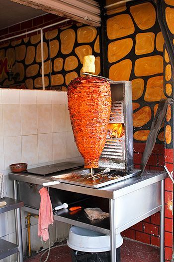 Tacos de trompo (aka tacos al pastor), my favorite tacos in the world. Thinly sliced marinated pork is skewered and roasted on a vertical rotisserie, then sliced thinly into tacos.: Vertical Rotisserie, Tacos Mexicanos, Taco Shop, Tacos Al Pastor, Doner Kebab, Mexican Tacos, Backyard Grilling, Marinated Pork, Fire Cooking