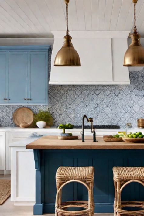 Modern kitchen with blue cabinets, wooden island, wicker stools, and brass pendant lights. Farmhouse Coastal Kitchen, Coastal Modern Kitchen, Coastal Cottage Kitchen, Coastal Kitchen Ideas, Modern Coastal Kitchen, Coastal Kitchens, Coastal Apartment, Beach House Kitchen, Nautical Kitchen