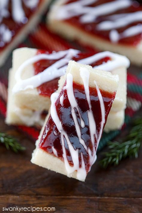 Ribbon cookies filled with jam and glazed in icing. A cookie standing up right on a wooden platter. Chicken And Pineapple Skewers, Raspberry Shortbread Bars, Ribbon Cookies, Pillsbury Cookie Dough, Best Cookie Recipe Ever, Dusting Tips, American Dessert, Easy Bar Recipes, Delicious Christmas Desserts