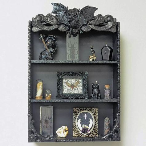 Out Of The Darkwell | Los Angeles, CA | New and now available! Vampire Bat Gothic Shelf. Beautifully detailed 3 tier shelf with a resin bat at the top. Great size for small curio… | Instagram Vampire Manor, Gothic Shelves, Dark Academia Garden, Bat Shelf, Gothic Bookcase, Gothic Shelf, Dark Room Decor, 3 Tier Shelf, Bat Decor