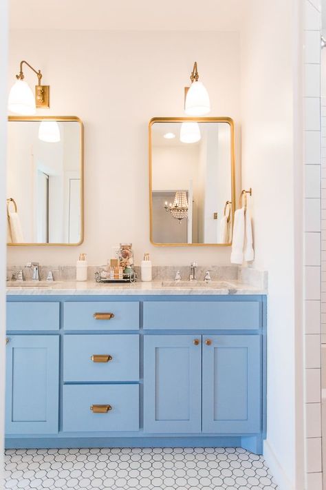 Modern farmhouse bathroom with bright hydrangea blue vanity and marble countertops. Brass hardware, brass lighting, and brass mirrors complete the beach vibe of this home on Lake Eufaula. #bathrooms #makeover #color #paintcolors #brass #farmhouse #fixerup Brass Mirrors, Deco Pastel, Hydrangea Blue, Blue Vanity, Pretty Bathrooms, Bad Inspiration, Stunning Bathrooms, Modern Farmhouse Bathroom, Design Apartment