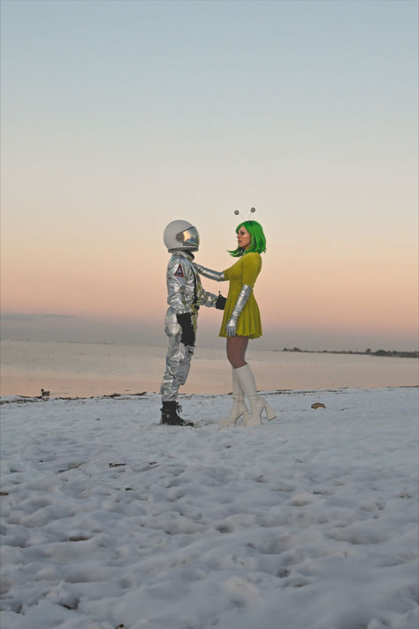 Alien and Astronaut Halloween costumes on a snow day sunset photography Martian And Astronaut Costume, Pinup Alien Costume, Mod Alien Costume, Nasa Astronaut Costume, Alien Halloween Costumes Diy, Vintage Space Costume, Retro Alien Costume Women, Aliens And Astronauts Costume, Space Babe Costume