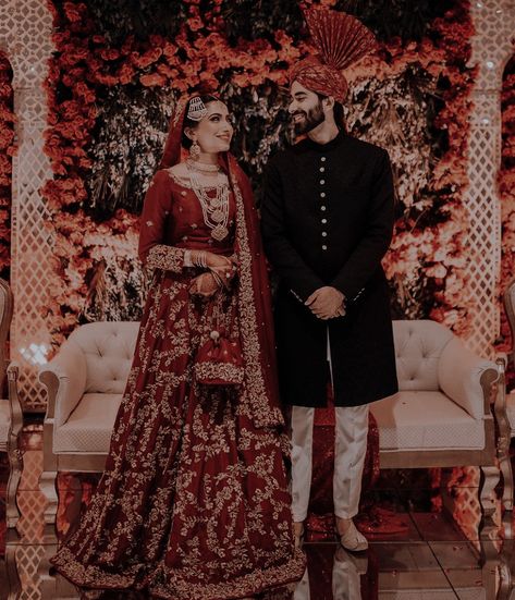 Maroon Couple Outfits Wedding, Bride And Groom Outfits Indian, Bridal Dresses Pakistani Barat Maroon, Maroon Bridal Dress, Nikah Poses For Couple, Muslim Bridal Lehenga, Black Groom Sherwani, Groom Barat Dress Pakistan, Maroon Sherwani