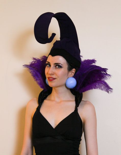 Inexpensive & easy Yzma costume from The Emperor's New Groove - made from feathers, coat hangers and a cloche hat. Emperors New Groove Costume Family, Kronk Costume Diy, Emperors New Groove Trunk Or Treat, Yzma And Kronk Costume Diy, Diy Yzma Headpiece, Ezma Emperor's New Groove Costume, Emporers New Groove Costumes, Izma Costume Diy, Kronk Costume