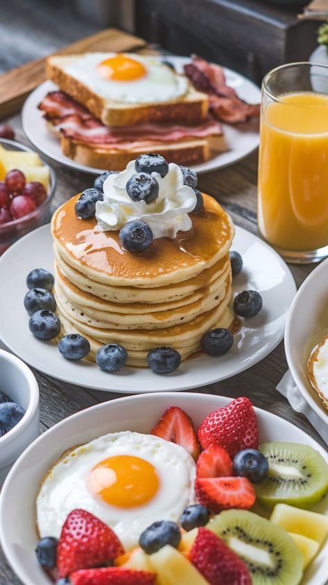 "Start your day right with this mouthwatering breakfast spread! Enjoy fluffy pancakes topped with fresh blueberries and whipped cream, paired with a sunny-side-up egg, crispy bacon, and a colorful assortment of fresh fruits like strawberries, kiwi, and pineapple. Perfect for a cozy weekend brunch or a delightful breakfast treat. Find more breakfast inspiration and recipes on our board!" Breakfast Pictures Aesthetic, Fancy Breakfast Aesthetic, Pancakes Bacon And Eggs, Breakfast Ideas Pancakes, Fancy Pancakes, Pancakes Aesthetic, Delicious Breakfast Ideas, Breakfast Spread, Fruit Pancakes