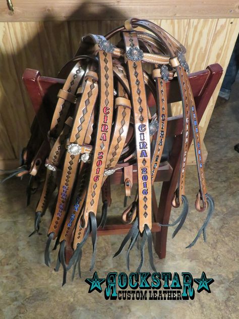 Pile of colorful custom award headstalls by Rockstar Custom Leather Rodeo Awards Ideas, Leather Rodeo Awards, Western Horse Tack Sets Barrel Racing, Tooled Leather Barrel Racer, Tooled Headstall, Breastcollars Barrel Racing, Award Ideas, Custom Awards, Custom Leather