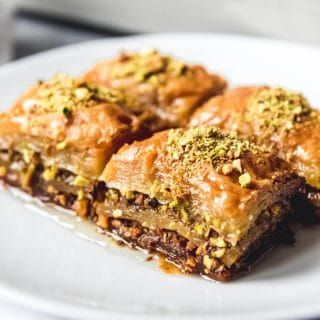 Turkish Baklava, also known as Fistikli Baklava or Pistachio Baklava is a deliciously rich, buttery, sweet dessert made from phyllo dough, finely ground pistachios, butter, and a syrup made from sugar, water and lemon juice.  That's it! Walnut Baklava, Turkish Sweets, Turkish Baklava, Sweet Pastries, Baklava, Walnut, Almond, Honey, Dessert