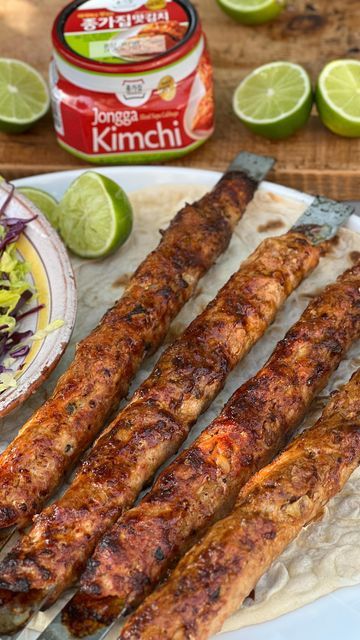 John Gregory-Smith on Instagram: "Kimchi Kebabs – Recipe Below AD these delish kebabs are inspired by Korean street food and flavoured with my favourite kimchi from @jongga_global – it gives the perfect kick to the kebab and the best tang to the finished dish. If you want to taste more Jongga Kimchi, visit their Flavourverse pop up in London from Sept 16th – Oct 8th – grab your tickets via the link in my stories x JGS Serves 4 For the kebab 100g Jongga Kimchi, finely chopped + extra for serving 600g minced pork 2 tsp garlic powder 2 tsp paprika The juice of ½ a lime Salt For the glaze 1 tbsp soy sauce 1 tbsp runny honey 1 tsp sesame oil 2 cloves garlic, crushed To serve 200g red cabbage, shredded 1 lettuce heart, shredded Flat breads 1. Sque Gregory Smith, Lime Salt, Korean Street Food, Kebab Recipes, Sesame Oil, Red Cabbage, Flatbread, Kimchi, Soy Sauce