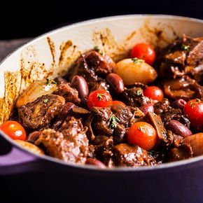 Lamb is braised in red wine before getting tossed with olives and tomatoes in this recipe from Houston chef Chris Shepherd's new restaurant, One Fifth. Lamb Neck Recipes, Lamb Stew Recipes, Braised Lamb, Lamb Dishes, Winter Dishes, Lamb Stew, New Restaurant, Cannellini Beans, Lamb Recipes