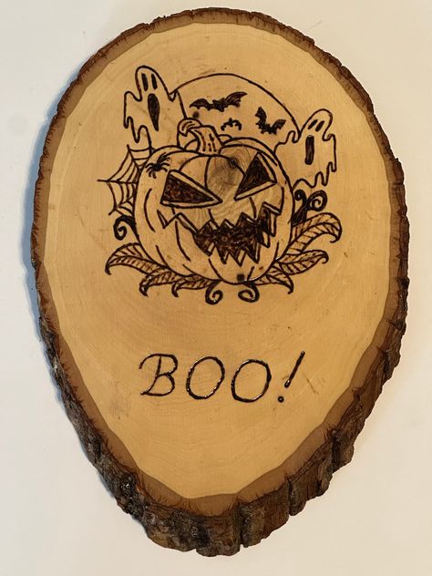 "One of a kind, wood burned plaque.  The design of this plaque is a pumpkin with ghosts behind it and the word \"boo!\" My designs are all hand drawn and then hand wood burned on to the wood plaque.  All plaques are sprayed with a clear coat and are appropriate for indoor hanging only.  Each plaque comes with a hanging kit." Halloween Wood Burning, Wood Burning Crafts, Wood Plaques, Wood Slices, Handcrafted Wood, Halloween Boo, Wood Burning, A Pumpkin, Pyrography