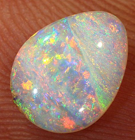 Discover the mesmerizing beauty of this 1 ct Boulder Opal Crystal Pipe Stone, hailing from the colorful land of Winton, QLD in Australia. Its vibrant hues of red, orange, yellow, green, and blue are artistically shaped into a teardrop, creating a truly unique masterpiece. Immerse yourself in the world of crystals and gems with this SOLID NATURAL AUSTRALIAN BOULDER OPAL LOOSE STONE. Follow us for more captivating content! Rock And Minerals, Minerals Crystals Rocks, Lightning Ridge Opal, Crystal Therapy, Australian Boulder Opal, Crystal Opal, Red Orange Yellow, Faux Stone, Amethyst Quartz