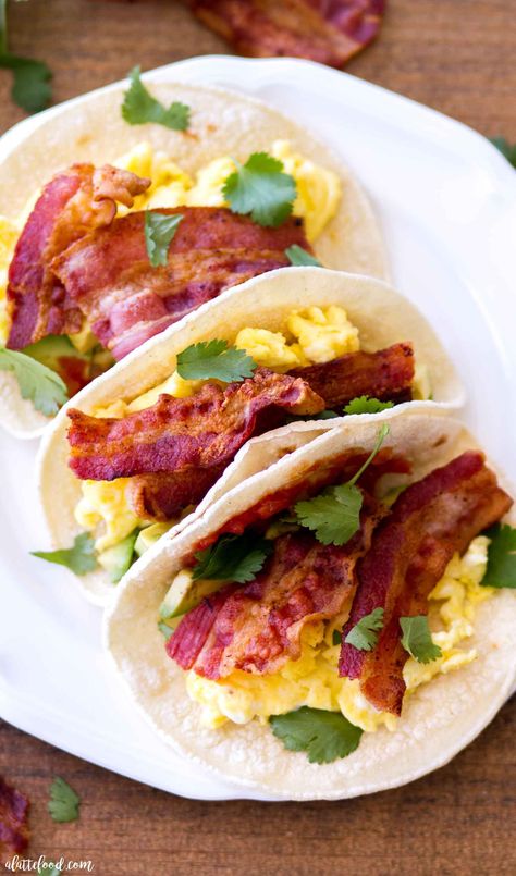 These Egg and Bacon Breakfast Tacos are full of hickory smoked bacon (Jimmy Dean® Bacon), fluffy scrambled eggs, salsa, cilantro, and avocado. Served on corn tortillas or flour tortillas, this breakfast taco recipe is sure to be an easy breakfast staple. This hearty breakfast recipe is perfect for Father’s Day, but easy enough to whip up any day of the week! easy egg tacos, how to make scrambled eggs, the best scrambled eggs Bacon Taco, Hearty Breakfast Recipes, Breakfast Tacos Recipe, Bacon Corn, Breakfast Taco, Egg And Bacon, Bacon Eggs Breakfast, Chicken Roll, Taco Recipe