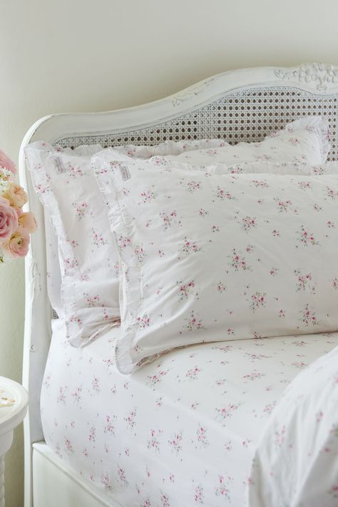 Add an elegant touch to your bedscape with the Rosabelle Petite Ruffle Pillowcases from Shabby Chic by Rachel Ashwell. Made from pure cotton with a 200 thread count, this set of 2 pillowcases are coated in a pretty floral design and finely finished with ruffle edges. Match with coordinating Rosabelle Bedset and fitted sheet for a complete set. Machine washable. Pillowcase 1 and Pillowcase 2 100% Cotton.