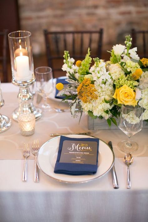 Yellow and navy blue wedding color palettes inspirations for 2024: mismatched bridesmaid dresses of yellow and navy blue, yellow bouquets with navy blue ties, navy blue and yellow aisle markers, navy blue wedding napkins, yellow table centerpieces… Navy And Yellow Wedding Colors, Blue And Yellow Spring Wedding, Blue And Yellow Table Setting, Navy Blue Yellow Wedding, Yellow Wedding Bouquets, Blue Wedding Napkins, Navy And Yellow Wedding, Bridesmaid Dresses Yellow, Yellow White Wedding