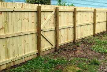 How to Fill in a Gap Under Fencing | Home Guides | SF Gate Fence Post Repair, Cedar Fence Pickets, Fence Pickets, Horizontal Fence, Fencing Companies, Cedar Fence, Privacy Fences, Vinyl Fence, Good Neighbor