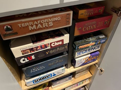 Boardgames organized in cabinets. Game Cabinet Organization, Game Cabinet Storage, Organize Deep Cabinets, Board Game Storage Cabinet, Kitchen Pans Organization, Organize Board Games, Board Game Shelf, Game Cabinet, Board Game Storage