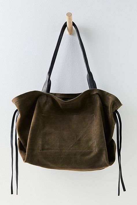 Easy and relaxed, this chic tote bag is featured in a slouchy style and canvas fabrication, with leather details for an edgy touch. **Features:** Tote style, slouchy design, canvas fabrication, leather tie sides, top handles, cinched closure, interior zip pocket **Why We | Daybreaker Tote by FP Collection at Free People in Rock Uni Bag, Boho Tote Bag, Slouchy Tote, Slouchy Bag, Slouchy Style, Leather Tie, Craft Tote Bag, College Bags, Winter Girls