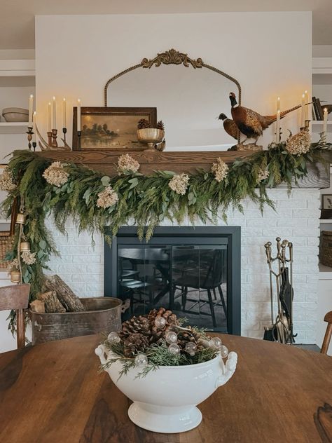 This is my all time favorite garland! I added some hydrengeas for a tie over between thanksgiving and Christmas and love how it turned out! Target Mantle Decor, Fireplace Mantle Decor Greenery, Year Round Fireplace Garland, Greenery Fireplace Decor, Eclectic Mantel Decorating Ideas, Mantle In Dining Room, Year Round Mantle Garland, Everyday Garland For Mantle, Cottagecore Fireplace Mantle