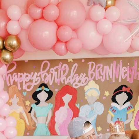 Jessica Crum on Instagram: "in our princess era 👑💖 what a special day celebrating our sweet girls. brynnleigh just turned FOUR & brooklyn turns ONE next week! (how is that possible? I swear I just had her 😭). so we celebrated like royalty with friends, family, and even our favorite princesses! those excited squeals will forever be embedded in my brain. never grow up, my girls.   shout out to my amazing vendors who helped pull this together 🫶🏼 balloons: @ohsnapletsparty  paint banner: @afterninedesigns  tables & chairs: @houstontentsevents  cake & cupcakes: @buttercuphouston  princesses: @fairestofallparties  dresses: @tutudumonde 📸: @therosemaryhen" Princess Fifth Birthday Party, Cheap Princess Party Ideas, Princess Party Themes, Four Year Old Princess Party, Second Birthday Princess Theme, Forever A Princess Birthday Party, Forever A Princess, Disney Princess Third Birthday Party, Princess Birthday Party Crafts