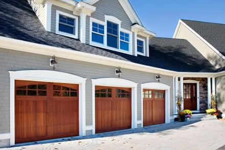 Gray exterior paint, stark white trim, wood doors. Small Roof Over Garage Door, Brown Garage Doors, Wood Doors White Trim, Addition Exterior, Garage Trellis, Precision Garage Doors, Grey Internal Doors, Carriage Style Garage Doors, Garage Door House