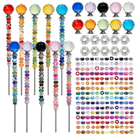 PRICES MAY VARY. Fairy Garden Kit: This 230 piece beaded garden stakes kit provides all necessary components for DIY fairy wands including 200 assorted round beads, 10 colorful crystal stoppers, 10 threaded rods, 10 nuts for complete creative freedom in designing unique garden stakes and fairy wands. Easy DIY Project: Simply screw beads and crystal toppers on the skate, add beads as you want and tighten the beads with nuts which are included. Widely applicable to garden, courtyard, lawn, terrace Diy Beaded Garden Stakes, Unique Yard Art, Crystal Plugs, Fairy Garden Kit, Pen Craft, Decorative Garden Stakes, Outdoor Living Decor, Fairy Wands, Garden Kits