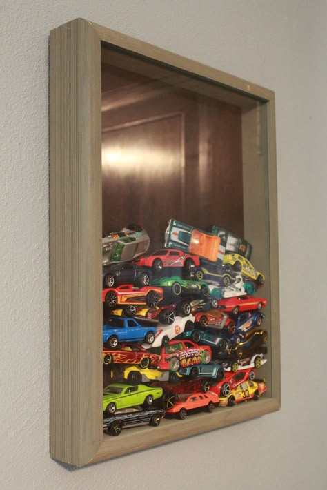 Shadow boxes are a great way for displaying any collection. Using one to showcase matchbox cars is perfect in a little boy's room or in the man cave. Like this idea? See the house it came from here. It's for sale! http://www.trulia.com/property/3110202504-2525-7th-St-East-Moline-IL-61244 Hotwheels Display Ideas, Hotwheels Storage Display Kids Rooms, Dinky Car Display, Hot Wheels Shadow Box Car Storage, Matchbox Car Wall Storage, Matchbox Car Display, Hot Wheel Collection Wall, Model Car Display Shelf Kids Rooms, Hot Wheel