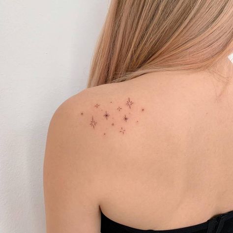 Fine line stars tattoo on the shoulder. Tattoo Ideas Back Of Shoulder, Fine Line Tattoo Ideas Shoulder, Stars Tattoo Back Shoulder, Fine Line Tattoos Shoulder, Star Tattoo On Back Of Shoulder, Small Star Tattoos On Shoulder, Stars On Back Tattoo, Shoulder Stars Tattoo, Stars Tattoo On Shoulder