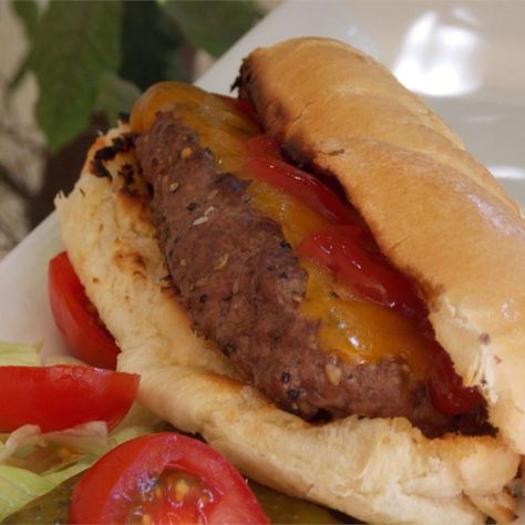 All-American Burger Dog | "This 'burger dog' is far more than a hot dog-shaped cheeseburger. It's a one-handed wonder that's perfectly proportioned and easier to eat than a regular cheeseburger." Toasted Hot Dog Buns, Burger Dog, Hot Dog Sauce Recipe, Hotdog Chili Recipe, American Burger, July 4th Recipes, Loose Meat, Juicy Hamburgers, Hot Dog Sauce