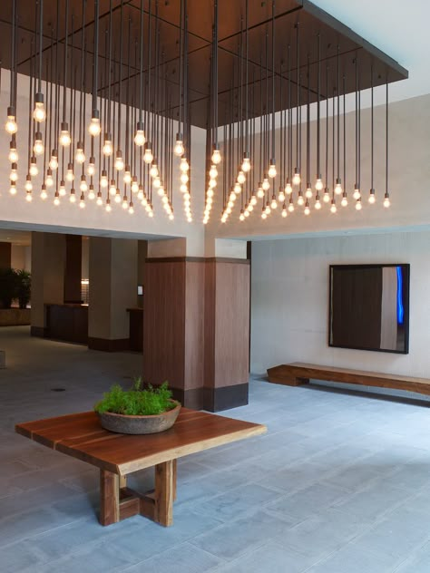 SERGIO MERCADO DESIGN | West Side Lobby Lobby Lighting, Rustic Entry, Blitz Design, Hotel Light, Rustic Light Fixtures, Lights Hanging, Home Lighting Design, Wooden Chandelier, Entryway Lighting